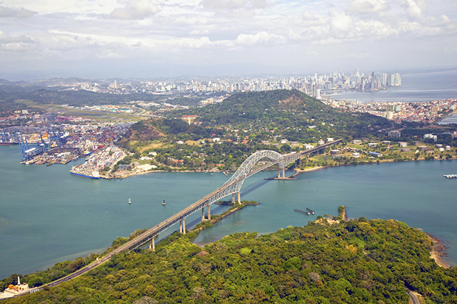 Aerial view of the Bridge of the Americas at the Pacific entrance to the Panama Canal with Panama City in the background. Aerial view of the Bridge of the Americas at the Pacific entrance to the Panama Canal with Panama City in the background.