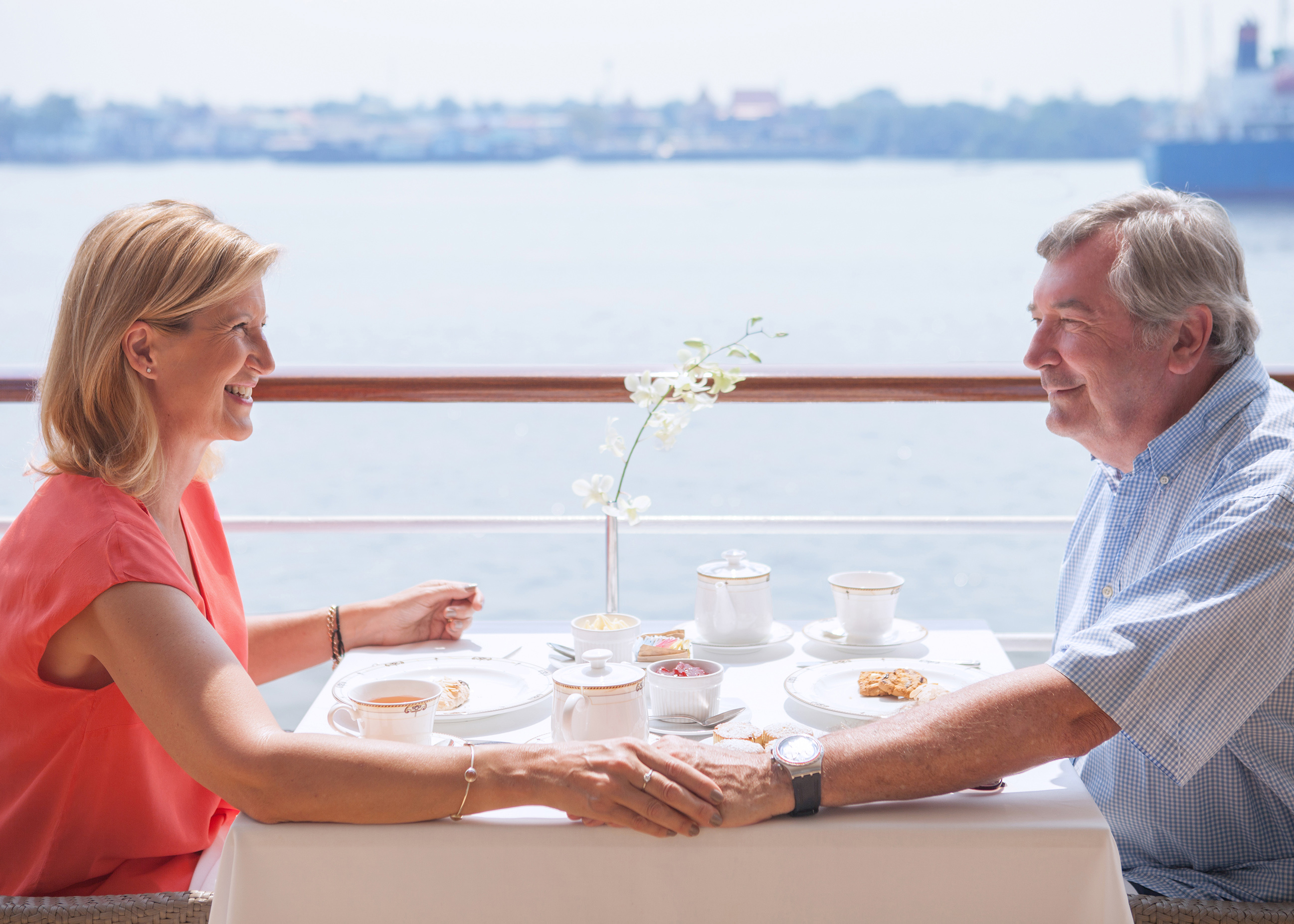 Couple in Club Veranda stateroom aboard a cruise ship — Travel Planners International