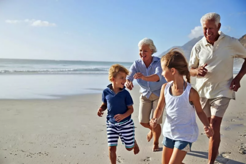 family running on the beach