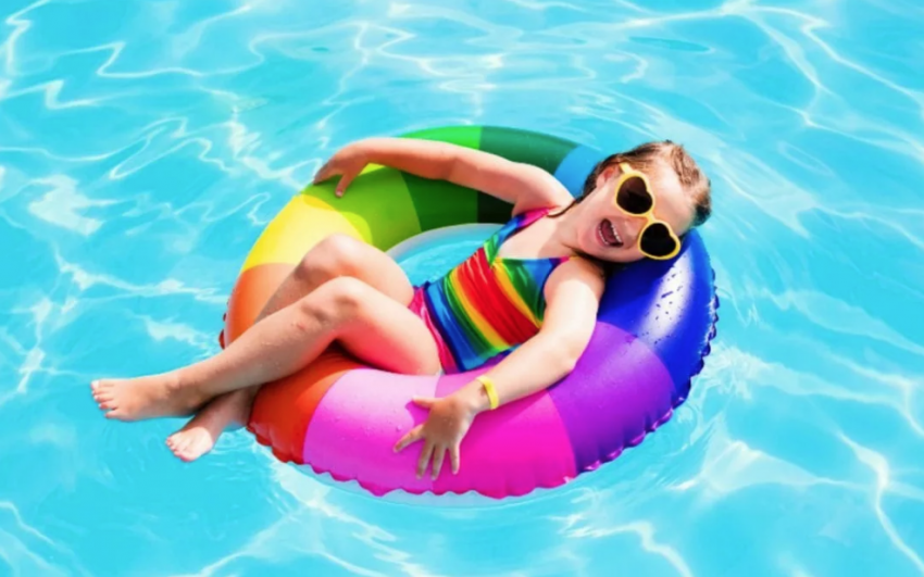 little girl floating in a pool
