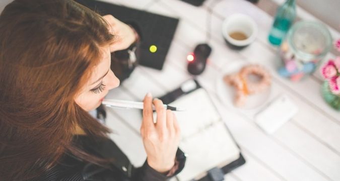 A Travel Planners travel agent helping to organize and plan her client's upcoming trip.